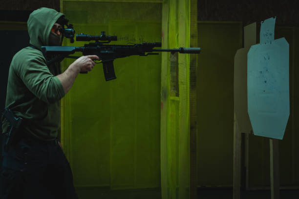 istock A man engages in tactical rifle shooting with nightvision at a shooting range in dark. 1973117277
