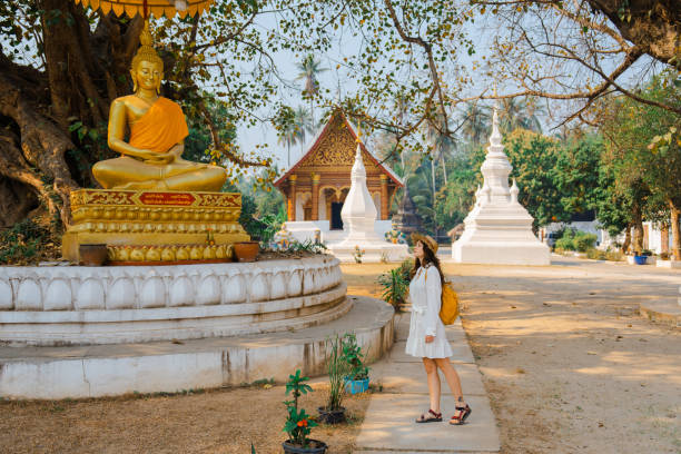istock Woman exploring buddhist temple in Laos 1973146067