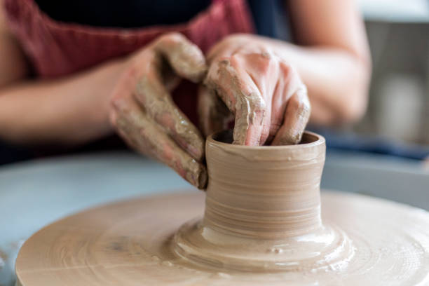 istock Caucasian woman molding ceramics with her hands 1973146622