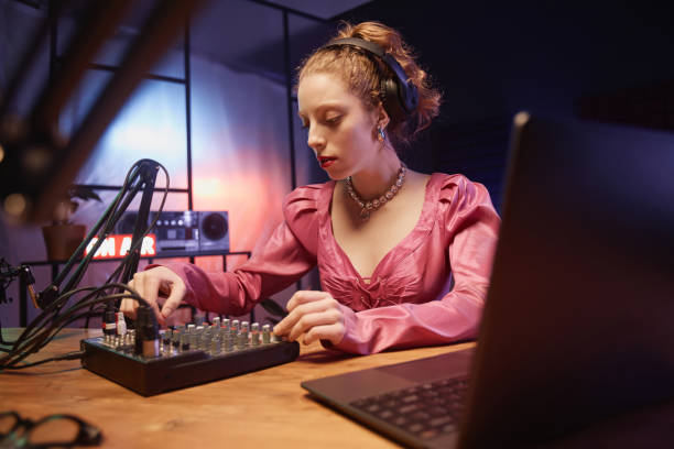 istock Stylish Girl Using Audio Mixer at Podcast 1973173797