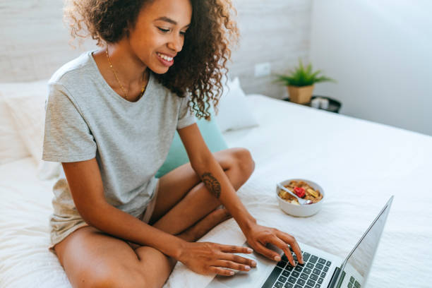 istock Woman writing on laptop at home 1973184145