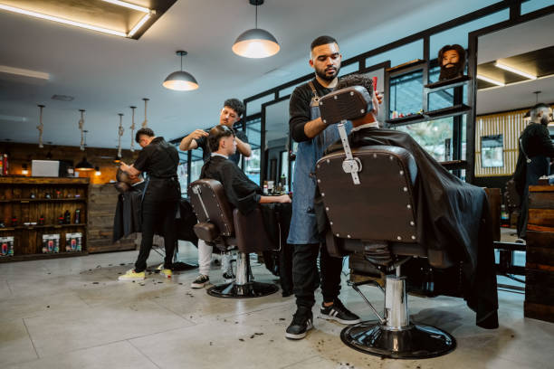istock Professional hairdressers serving clients in salon 1973194130