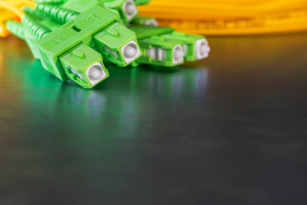 istock Fiber optic connectors on a colourful metallic background 1973231870