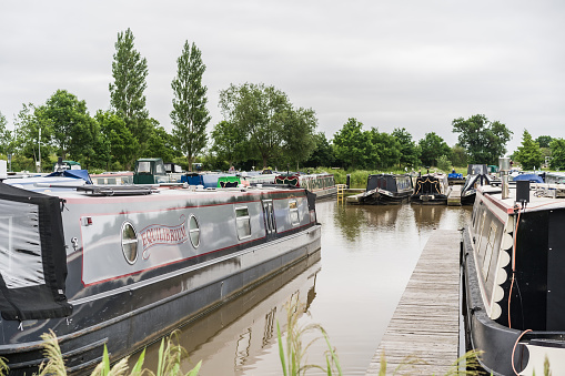 Nantwich, Cheshire, England, June 6th 2023. Marina with traditional parked narrowboats, transport, tourism and editorial travel illustration.