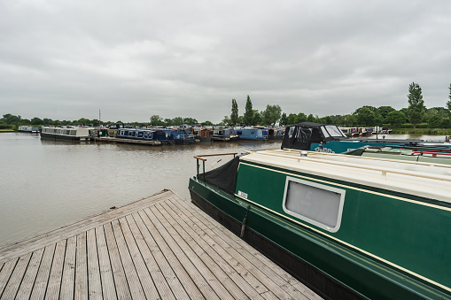 Nantwich, Cheshire, England, June 6th 2023. Marina with traditional parked narrowboats, transport, tourism and editorial travel illustration.