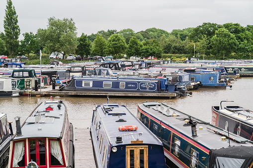 Nantwich, Cheshire, England, June 6th 2023. Marina with traditional parked narrowboats, transport, tourism and editorial travel illustration.