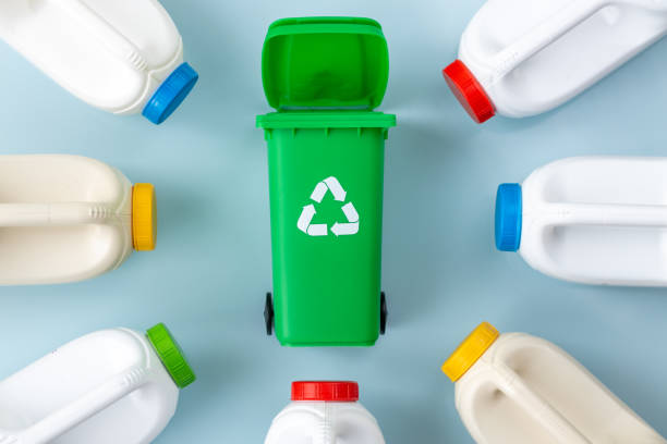 istock Segregation of plastic waste, green garbage bin and plastic bottles on a beautiful blue background, environmental concept 1973266454