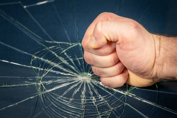 istock Clenched fist breaking tempered glass, concept, Anger, aggression, rage, Bad emotions 1973272831