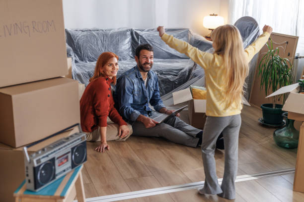 istock A family of three using a laptop while unpacking moving boxes 1973292888