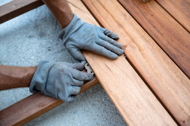 istock Hand placing wooden plank for outside terrace 1973297685