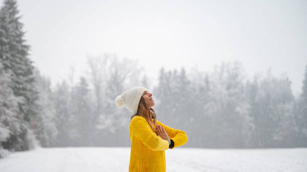 istock Young woman meditating in winter nature 1973297689