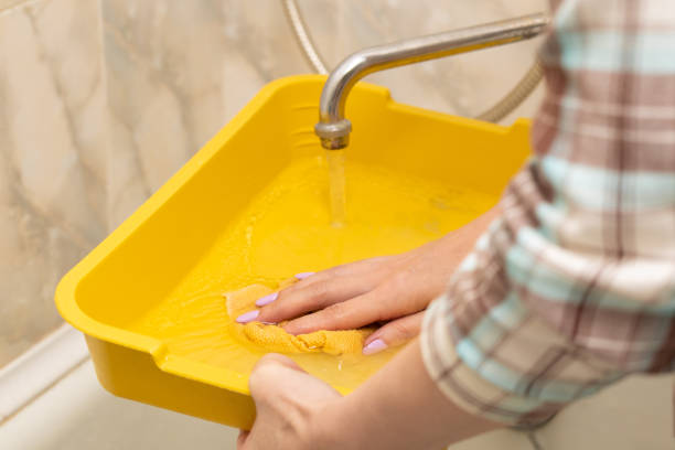 woman cleaning cat litter with a rag. domestic cat care