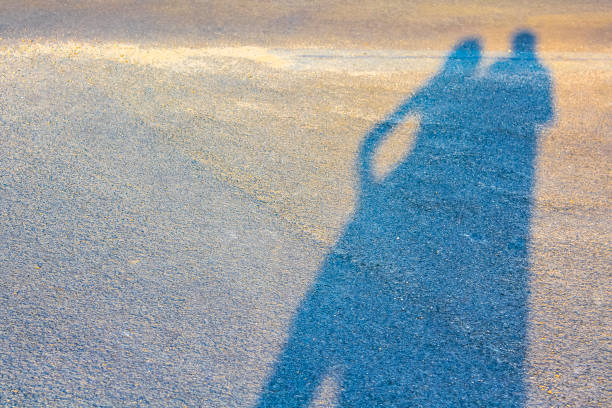 istock Shadow on the asphalt of a couple in Germany. 1973307163