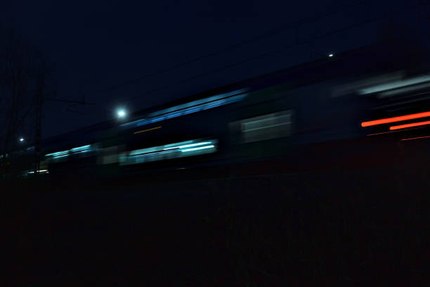 Train passing by next to a park at night