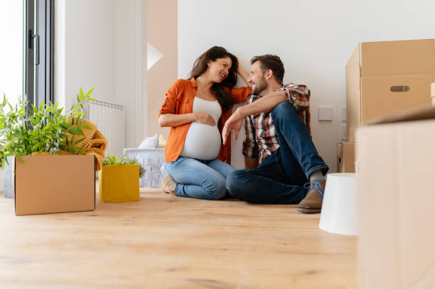 istock Beautiful young couple expecting a baby just moved into an empty apartment 1973359708