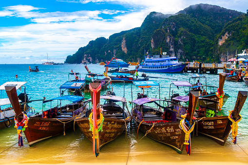 Koh Phi Phi Krabi Thailand 16. October 2018 Longtail boat long tail boats at the beautiful famous beach lagoon between limestone rocks and turquoise water on Koh Phi Phi Don island in Ao Nang Krabi Thailand.