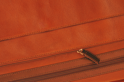 Part of Briefcase from genuine leather with pocket, zipper close-up, texture, background, copy space