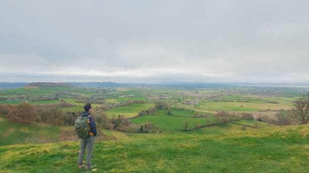 istock backpacker hiker on the high ground of Coaley Peak, Stroud, Gloucestershire, UK 1973369767