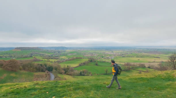 istock backpacker hiker on the high ground of Coaley Peak, Stroud, Gloucestershire, UK 1973369768