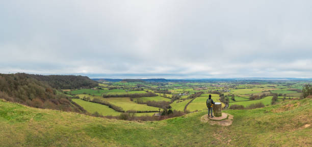 backpacker hiker on the high ground of Coaley Peak, Stroud, Gloucestershire, UK, daytime