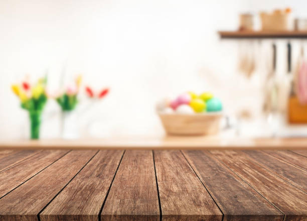 istock Table or surface on background of flowers and painted eggs. Easter concept. 1973370822