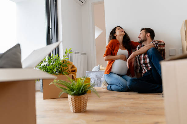istock Beautiful young couple expecting a baby just moved into an empty apartment 1973370829