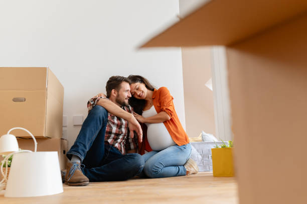 istock Beautiful young couple expecting a baby just moved into an empty apartment 1973371336