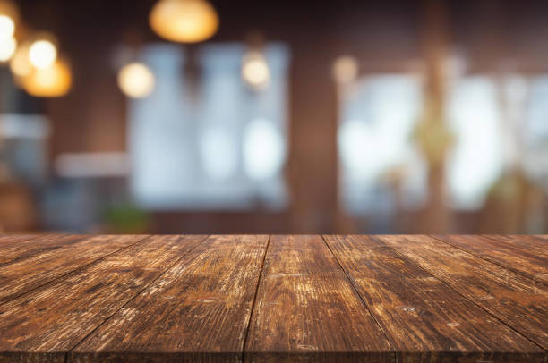 istock Table or surface on the background of a bar or cafe with light bulbs 1973383870