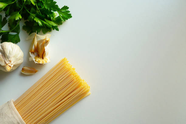 Happy beautiful Asian woman enjoy eating a testy spaghetti carbonara using a fork in Italian restaurant.