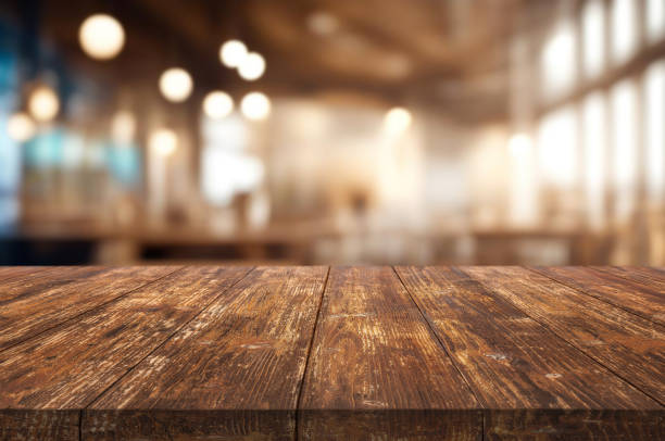 istock Table or surface on the background of a bar or cafe with light bulbs 1973387074