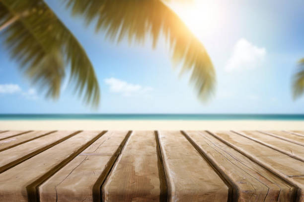 Table or surface with tropical swimming pool or beach in the background