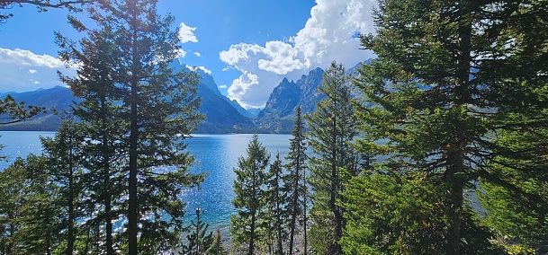 Heaven on Earth, with a scene of trees, water and mountain peaks on a clear sun filled day