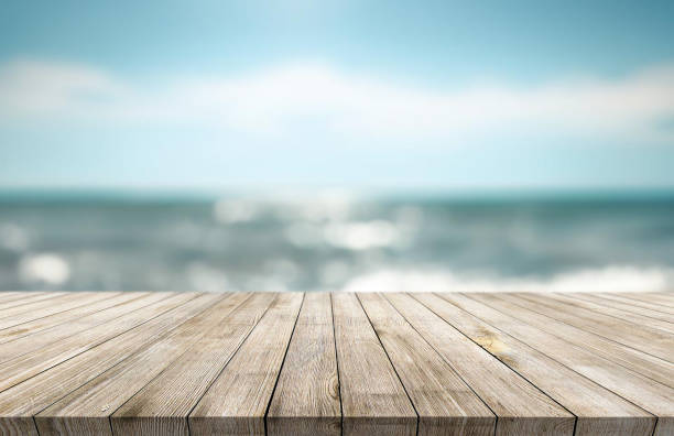 istock Table or surface with tropical swimming pool or beach in the background 1973392350