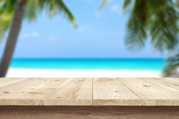 istock Table or surface with tropical swimming pool or beach in the background 1973396518