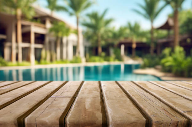 istock Table or surface with tropical swimming pool or beach in the background 1973397548