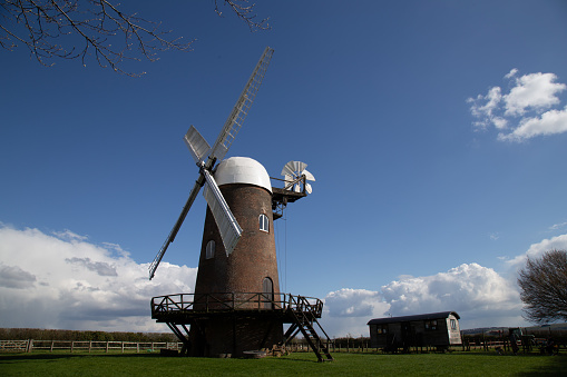 The historic Wilton Windmill under a bright blue sky