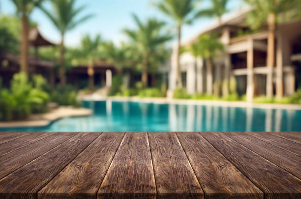 istock Table or surface with tropical swimming pool or beach in the background 1973398923