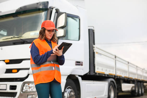 istock Blue Collar Female Worker, Truck and Logistics, Warehouse Manager, Checklist, Cargo Transportation, Shipping 1973414517