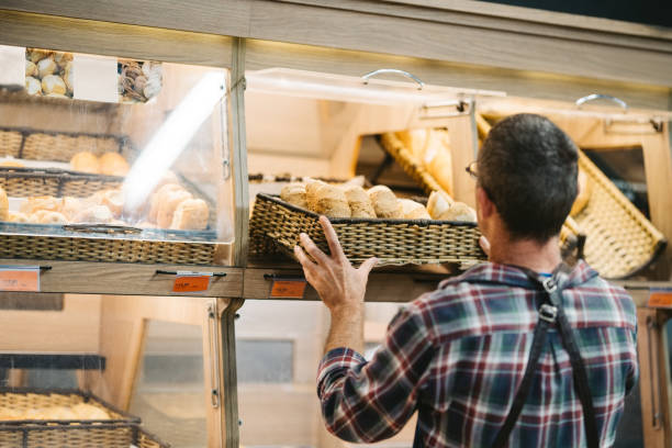 istock Male customer buying bread in grocery store 1973418677