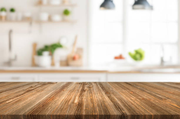 istock Wooden table or surface on the background of a beautiful kitchen 1973427517