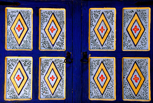 Blue wooden window with hand painted floral details, Mexican culture
