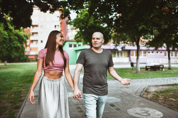 istock Female Holding Hands While Walking With Cancer Patient Husband In Park 1973473551