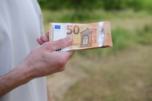 Close-up of 50 euro banknote in hands, Financial Literacy Education, Financial Analysis, Strategies for Protecting Against Money Inflation