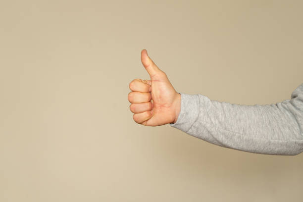 istock Thumb up isolated on beige background, with clipping path, concept Admiration, Excellent. 1973482947