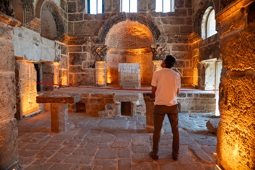 Photo of adult man in ancient church in city of Nusaybin, that is Nisibis. The church is known as the Syriac Orthodox Church of Jacob Of Nisibis.