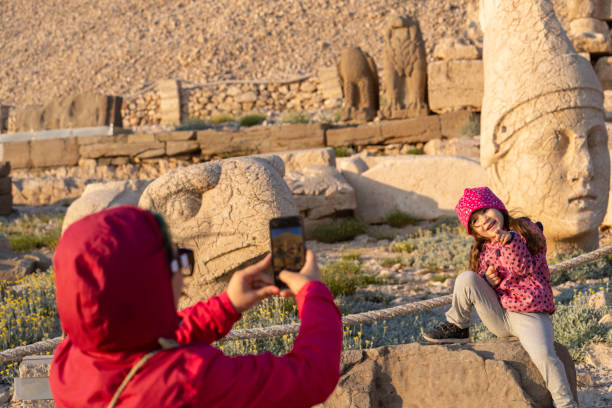 istock Mother photographing daughter in ancient ruins 1973511283