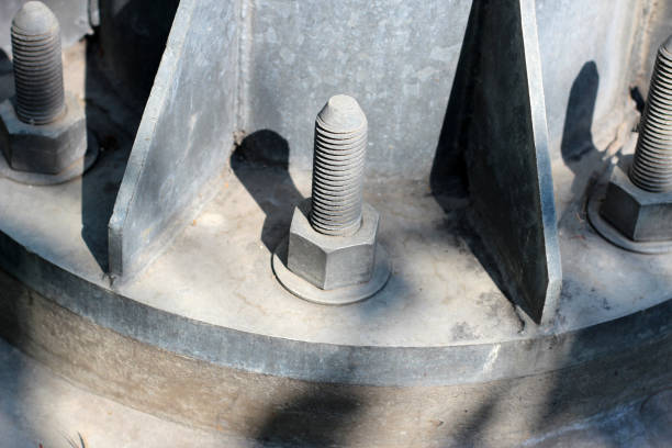 Large nuts and bolts on a metal pole