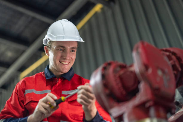 istock Maintenance Team Repairing Industrial Robotic Arm 1973529384