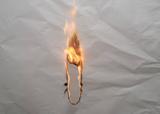 istock burning paper, glowing edge of paper 1973534582