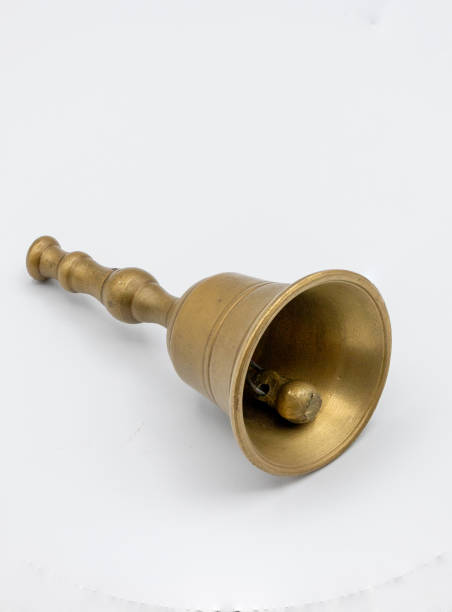 istock photograph of a small bronze bell on white 1973539254